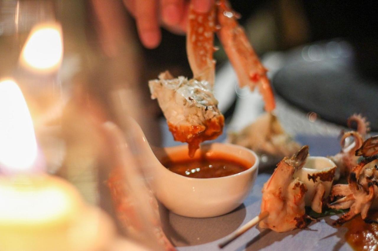 The Shore At Katathani - Adult Only - Sha Extra Plus Esterno foto A prawn being dipped into a bowl of cocktail sauce